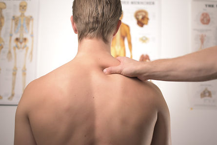 Clinician examining a patient’s shoulder